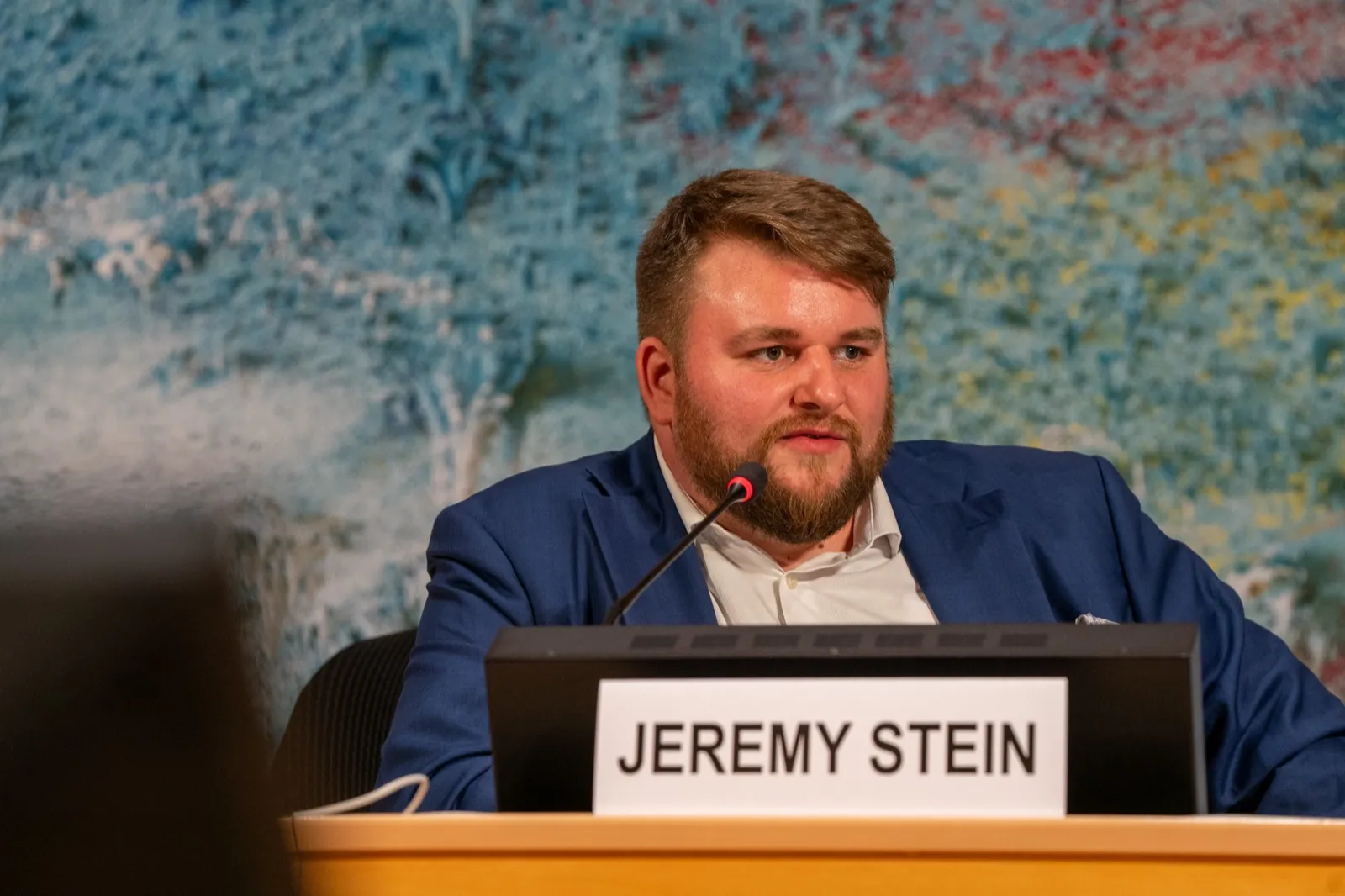 Jeremy T. Stein listening during a panel discussion at the AIFOD Geneva Summit 2026